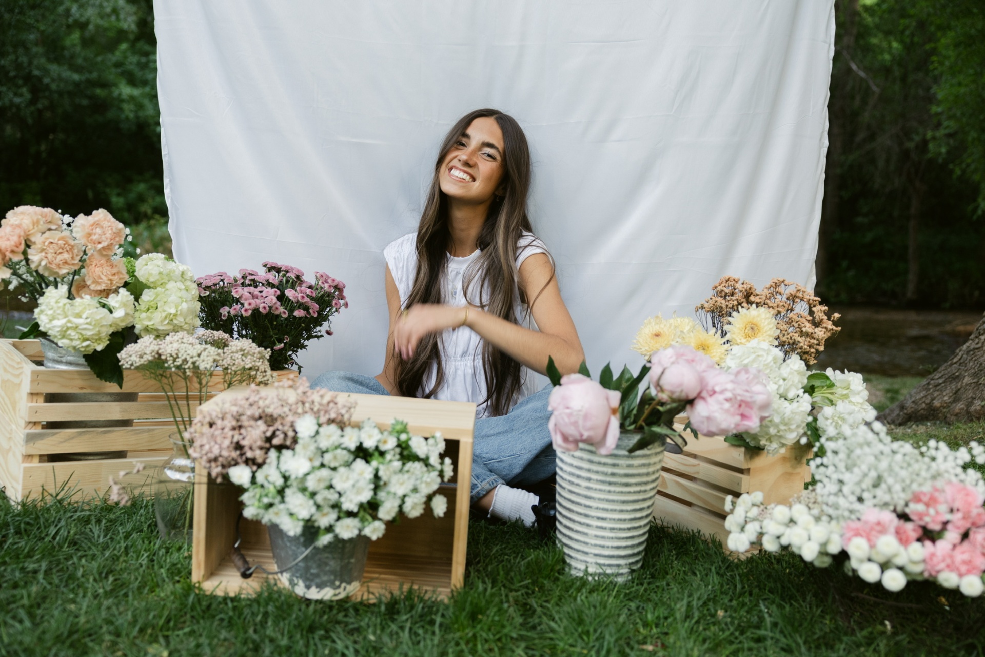 Aubrey sitting with flowers and smiling